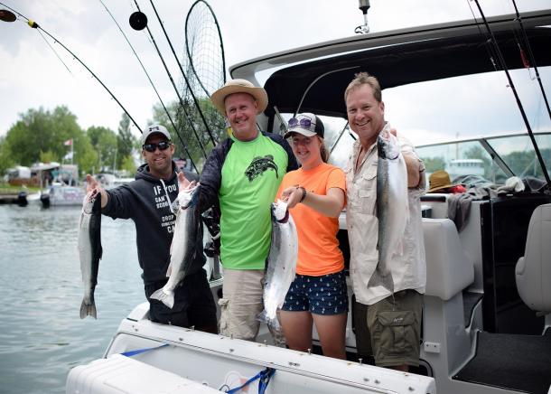 Family posing with fish they've caught