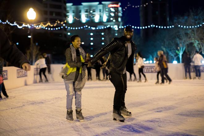 A couple holding hands, ice skating at Elmwood Park in Roanoke