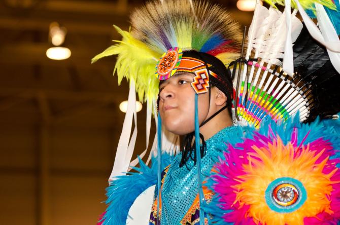 A Native American performs a dance in traditional attire at the Mid-America All-Indian Center in Wichita