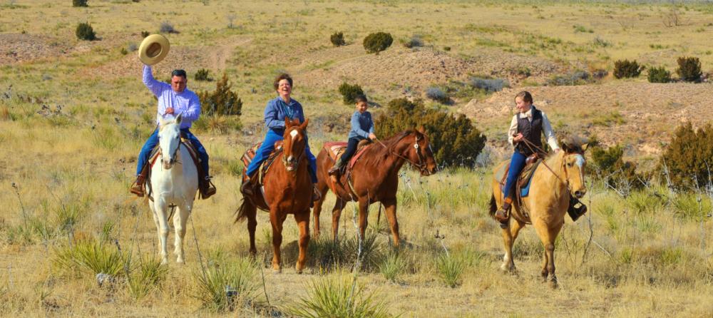 Family riding horses at Cowgirls and Cowboys in the West