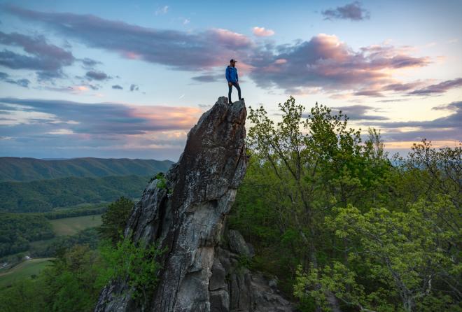 Hiker standing on the Dragon's Tooth monolith near Roanoke, Virginia