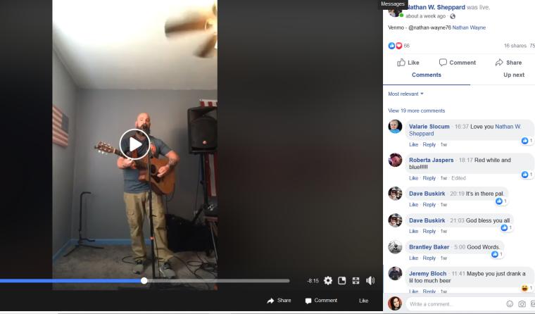 A screen shot of a Facebook Live video, one man plays guitar standing in a room and singing into a mic