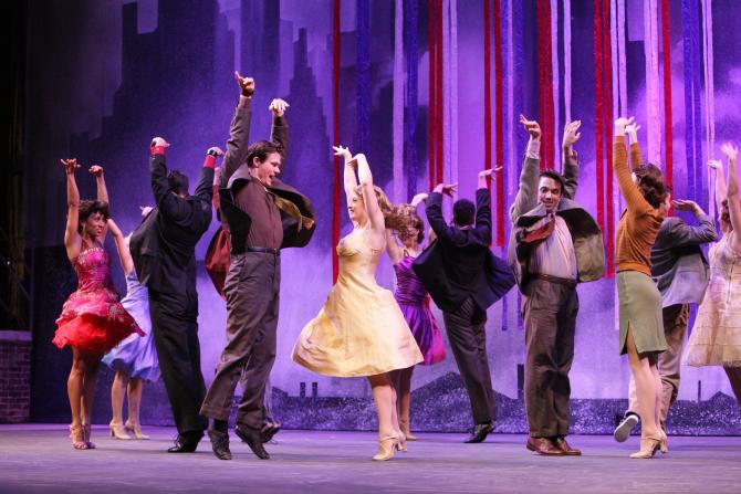 Music Theatre Wichita dance performers with hands raised