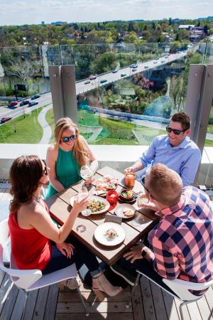 Two couples dining on the rooftop patio at VASO