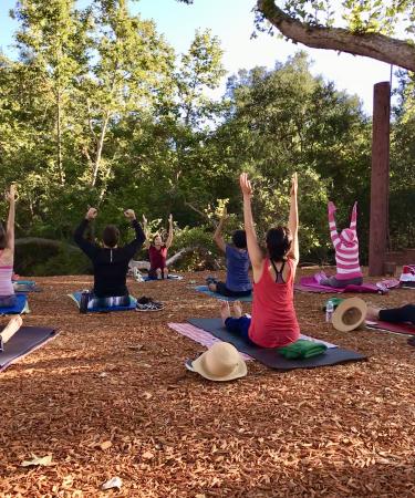 A group practices yoga in Bommer Canyon Community Park, located just a short drive from downtown Irvine.