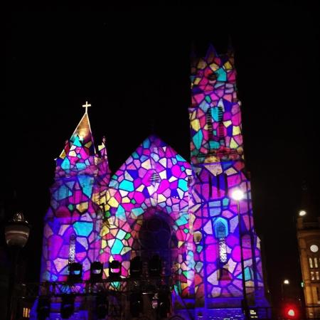 A church covered in stained glass light projections for BLINK Cincinnati