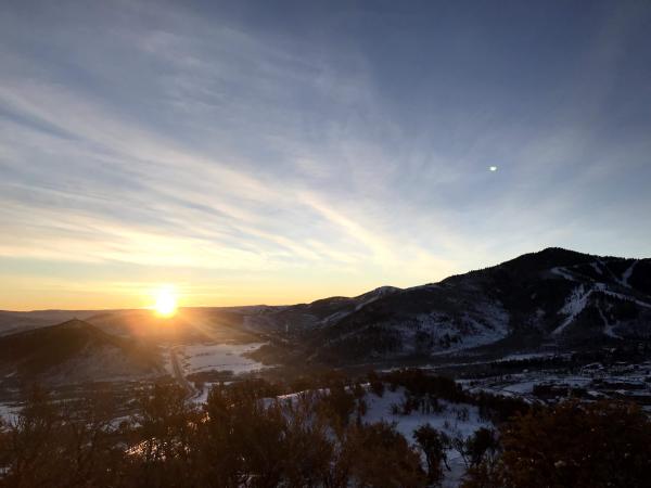 Sun rises over the mountain ridge