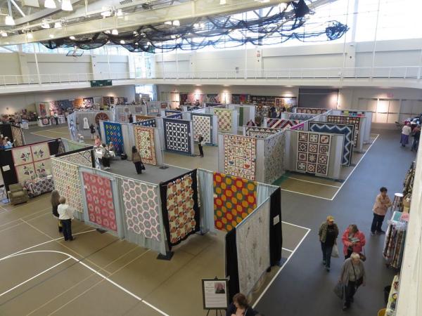 Quilts on display at a craft show.