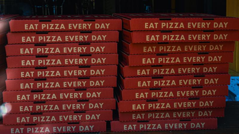 Sizzle Pie downtown by Melanie Griffin Twenty large pizza boxes stacked on top of each other. Each box says "eat pizza every day". Photo by Melanie Griffin