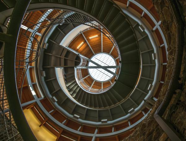 An upward photo of the winding stairs at the Big Well Museum