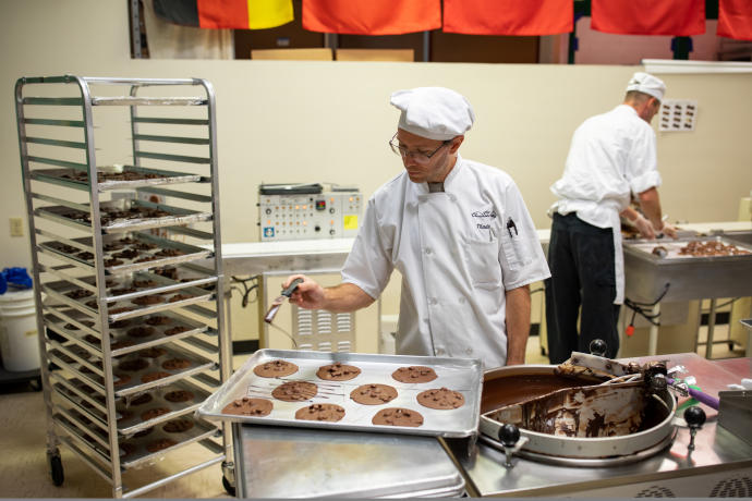 Embellishing chocolate rounds at The Chocolate Fetish