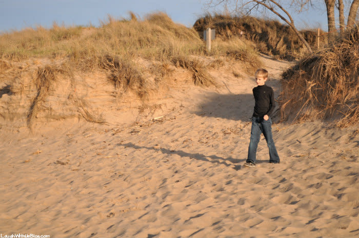 Boy in jeans walking on the Indiana Dunes West Beach sand