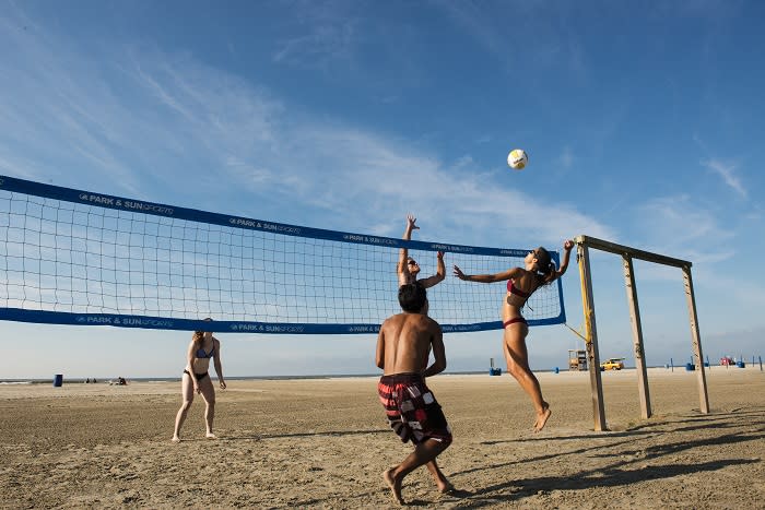 Playing beach volleyball at East Beach on Galveston Island