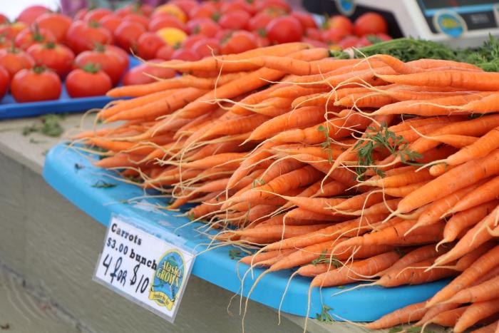 close up of orange carrots for sale at Farmers Market