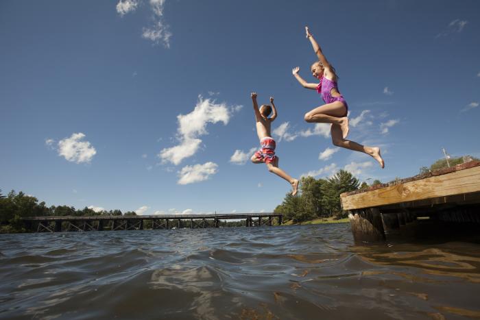 kids jumping into water