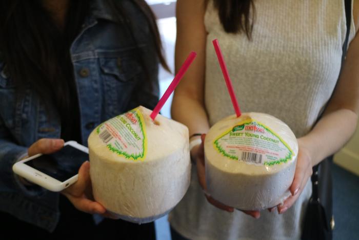 Women Holding Coconuts at OC Restaurant Week in Irvine