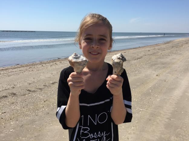 Girl shelling on Gulf beach | Creole Nature Trail