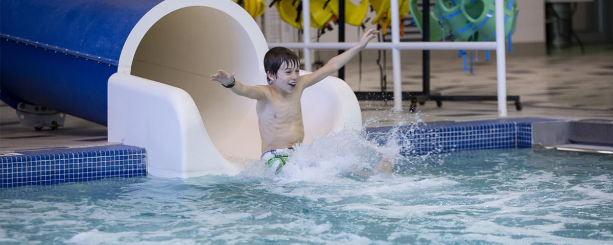 Kid Sliding Down A Water Slide At Monon Center In Hamilton County, IN