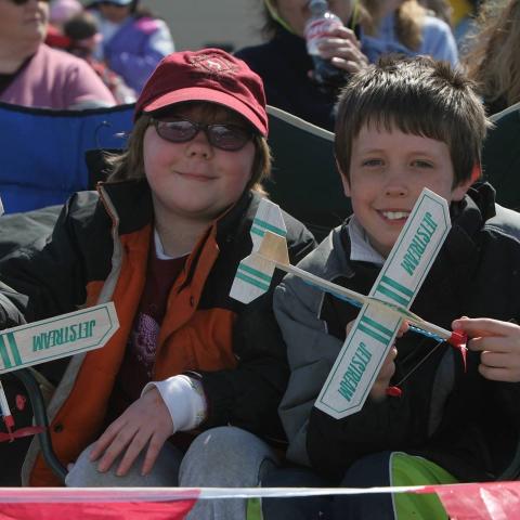 children hold up balsa wood toy planes