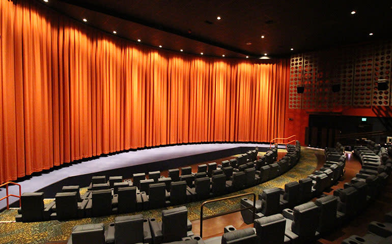 A stage curtain covers the WYO Theater screen.