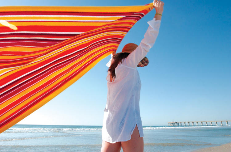 Woman on Wrightsville Beach with a colorful towel