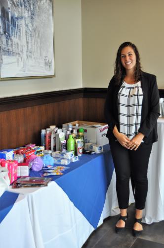 Stevie Church standing by donations table with hands crossed