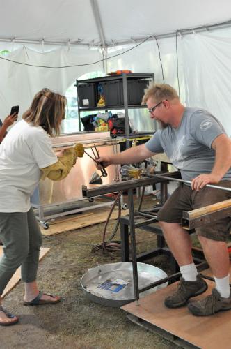 Gina working with the tongs as Gregg spins the tube