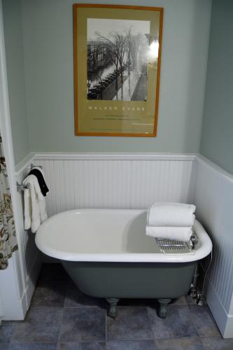 Tiny bathtub in alcove of gray bathroom