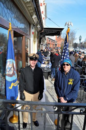 Navy officers posing with flag