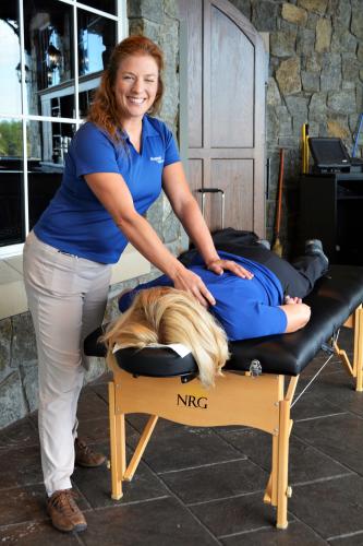 MaryJo lying face down on table getting a massage