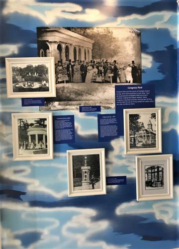 Closeup of one wall painted in multi-blues, covered with old photos and descriptive plaques