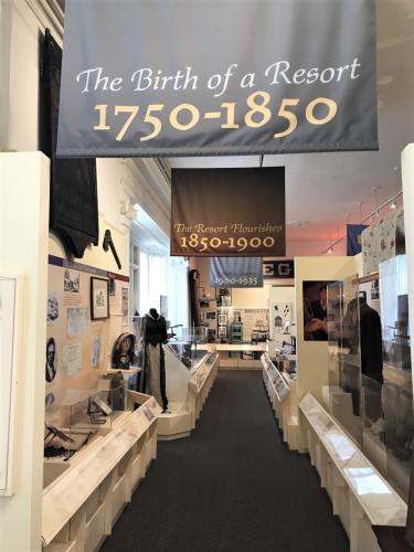 Three banners hanging in the orientation gallery listing years with corresponding historic displays on both sides