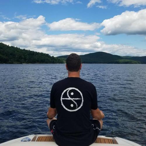 COESA man meditating by lake