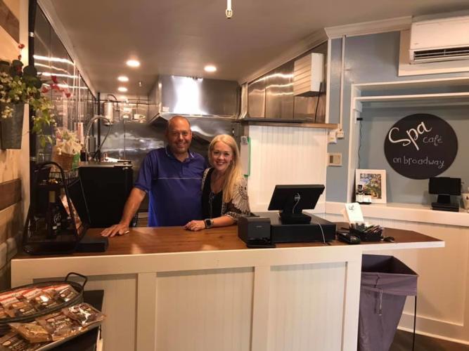Owners of Spa Cafe on Broadway posing behind the counter