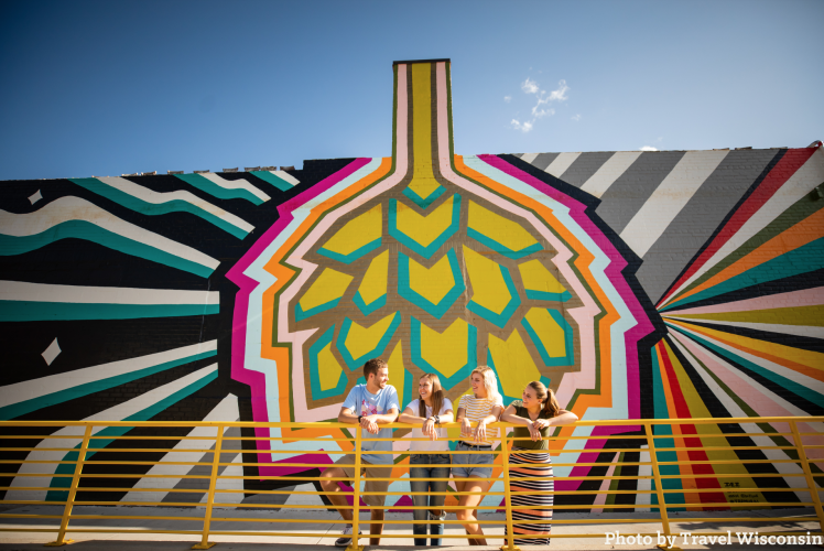 Friends in front of mural at Brewing Projekt