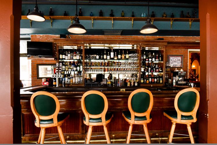 Inn at Saratoga Bar shot with four green stools