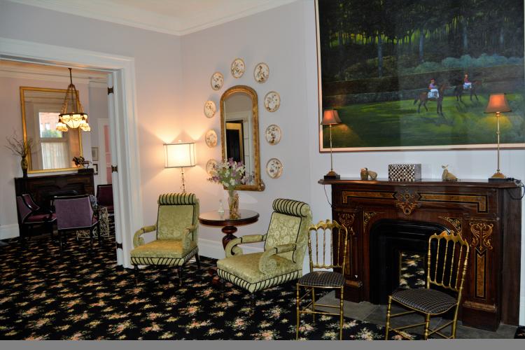 Saratoga Arms parlor with fireplace and large painting