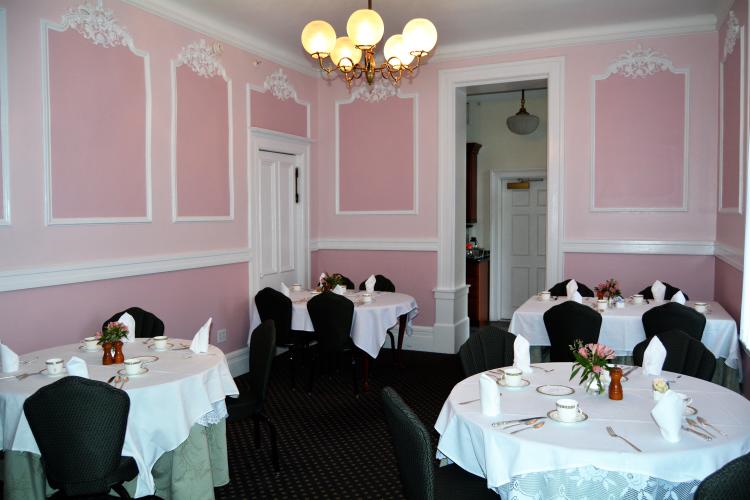Saratoga Arms pink dining room with tables with white tablecloths