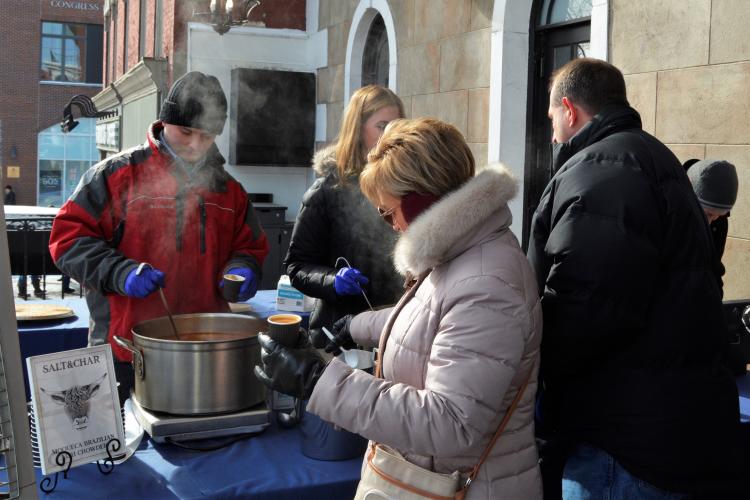 Chowder at Salt & Char being served to a woman in line