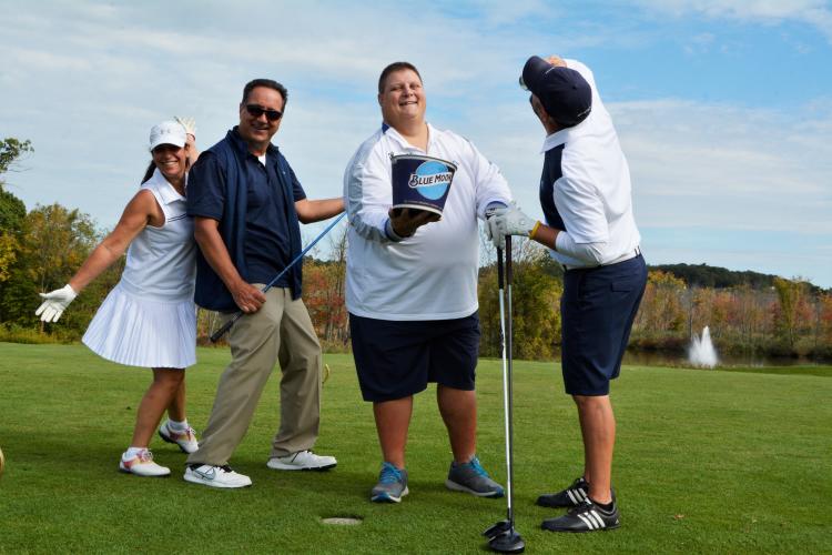 Foursome fooling around and holding bucket of Blue Moons