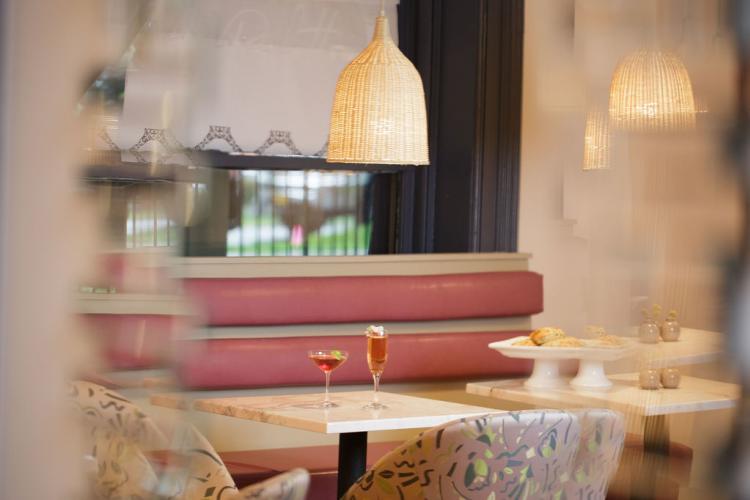 Palette Cafe pink dining booth with a martini and champagne glass in center of table and tray of pastries off to the side