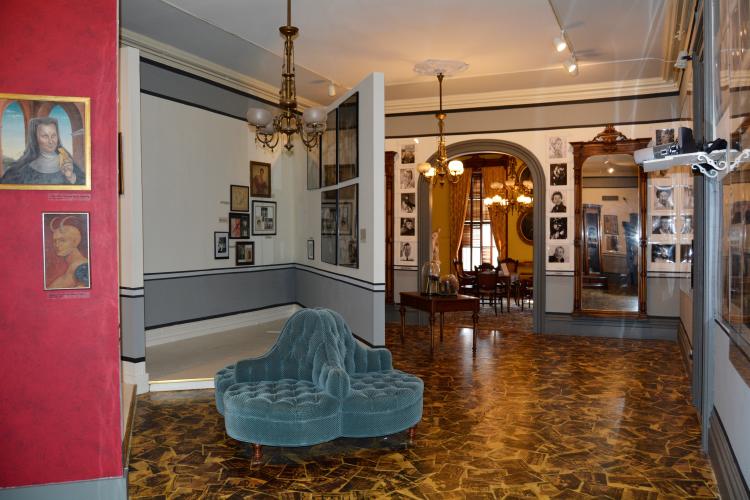 Internationally Famous exhibit with walls of portraits leading to gaming room in background