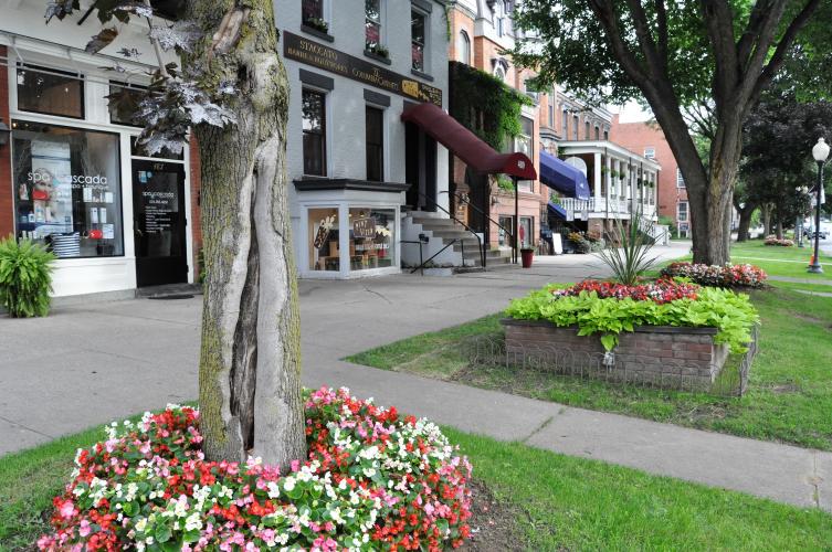 Beds with flowers and bright green plants by Pint Sized