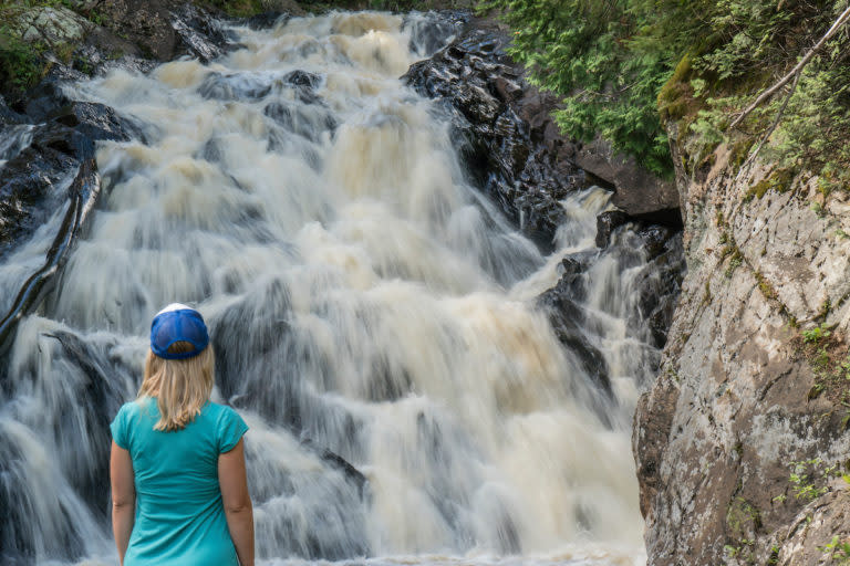 Woman Looking At Pinnacle Falls In Marquette, MI