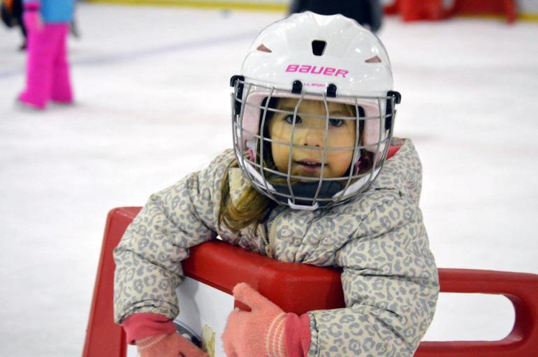 Young child learning to skate at Bill Gray's Regional Iceplex