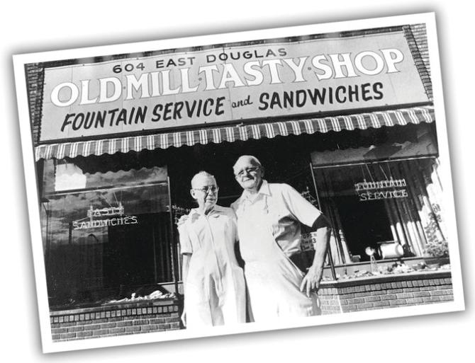 A black and white postcard shows the 2 original owners of Old Mill Tasty Shop standing in front of their restaurant in Wichita