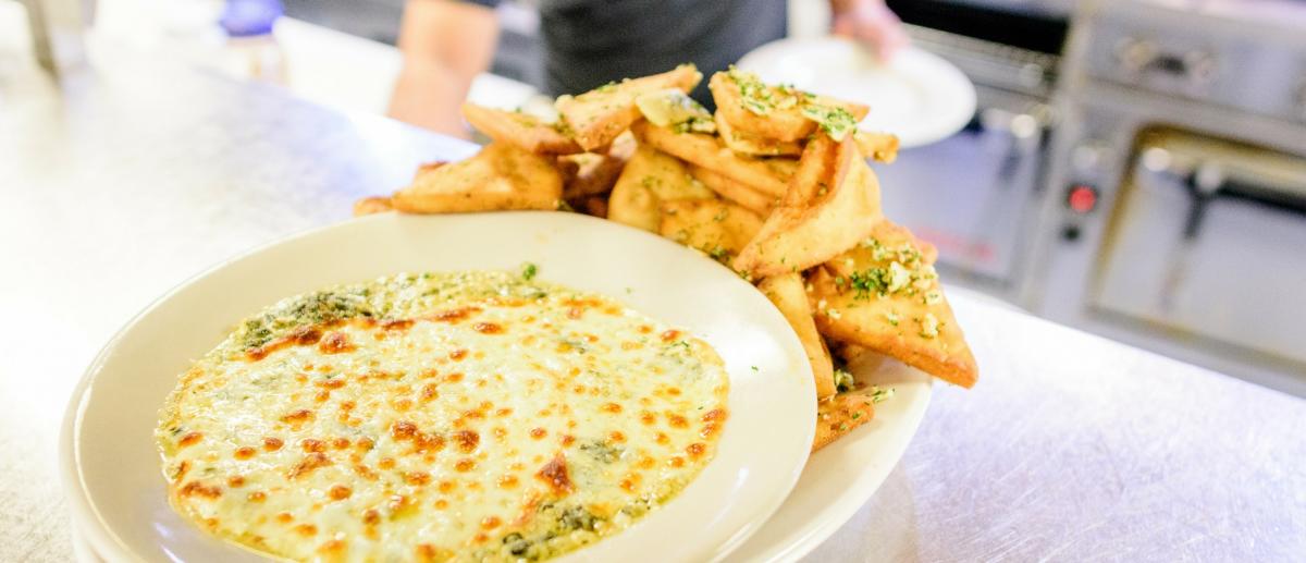 Spinach artichoke dip and bread served as an appetizer at Mannings Restaurant in Clayton, NC.