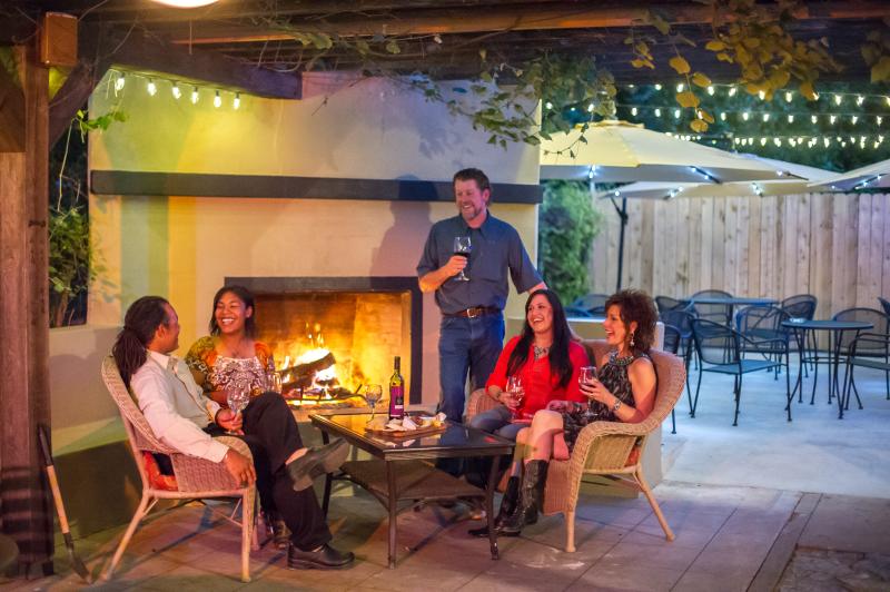 People drinking wine on the patio of Lincoln Street Wine Bar in Fredericksburg, TX