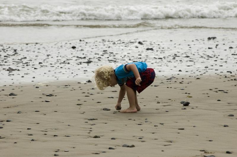 Child beachcombing on the Oregon Coast by Robert Petit Child beachcombing on the Oregon Coast by Robert Petit