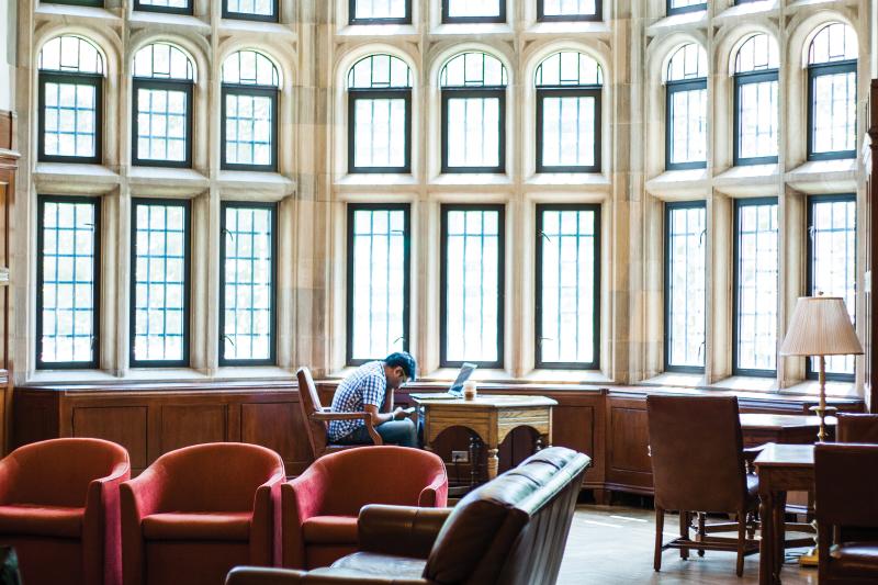 Student sitting at a desk with a laptop in the Indiana Memorial Union Lounge